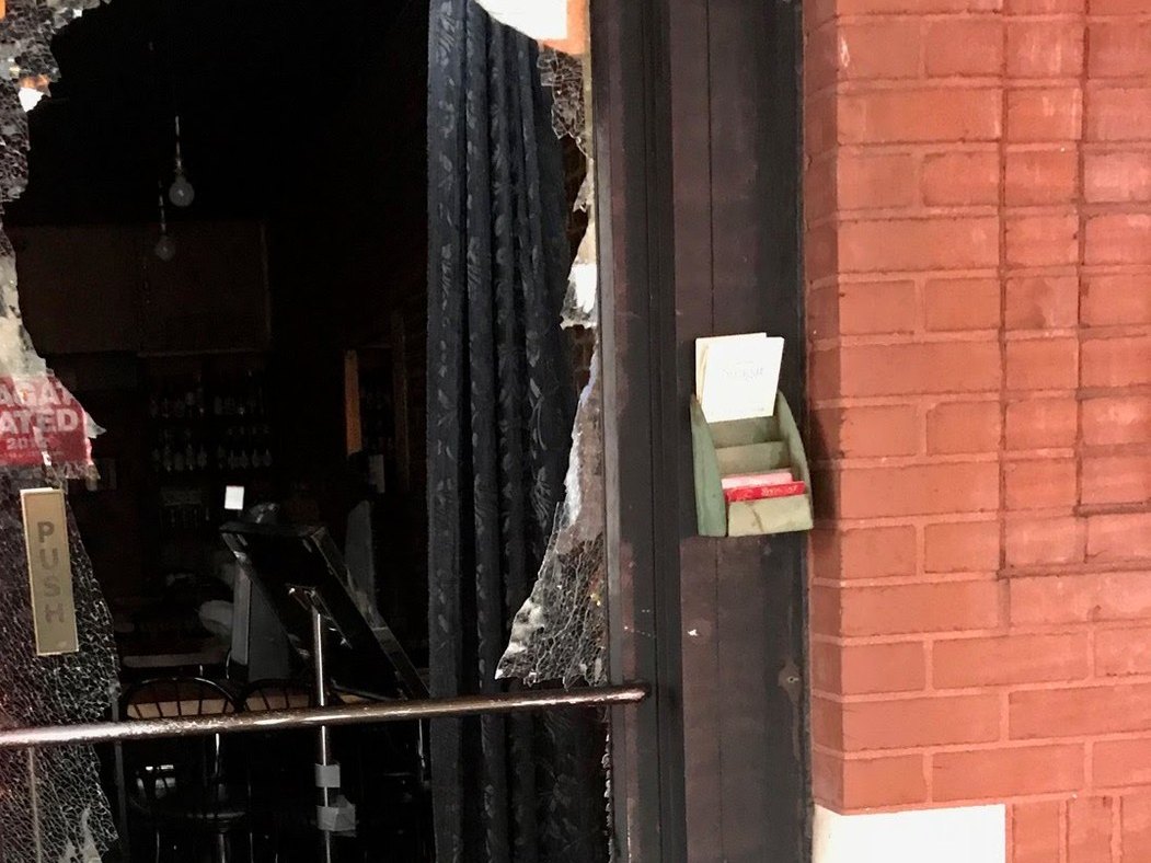Smashed glass door at a storefront needing 24/7 emergency service, Metro Local Locksmith
