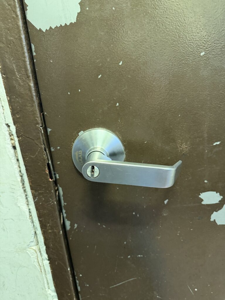 Commercial lever with a keyed cylinder on a metal service door, installed by Metro Local Locksmith on the Upper East Side, Manhattan