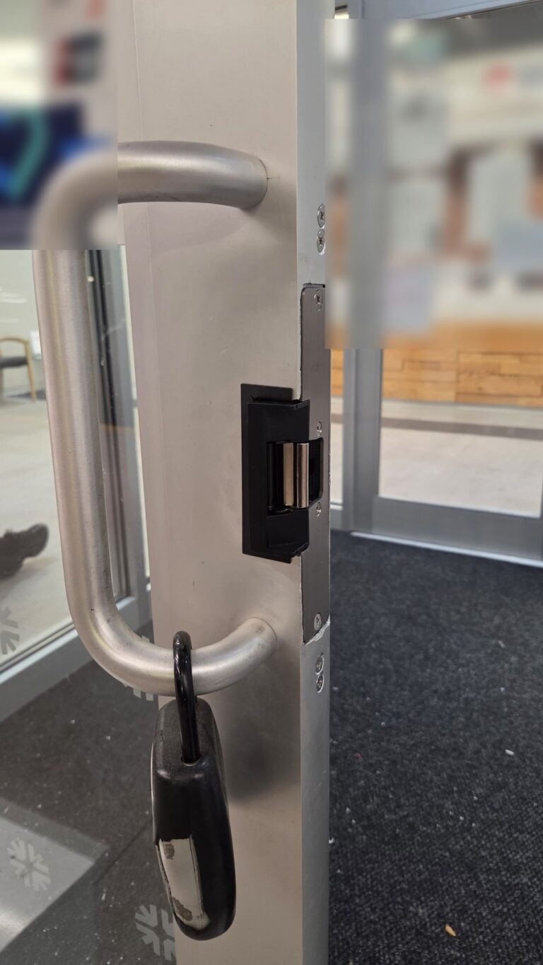 Electric strike in the stile of an aluminum and glass storefront door, installed by Metro Local Locksmith in the Bronx, NYC