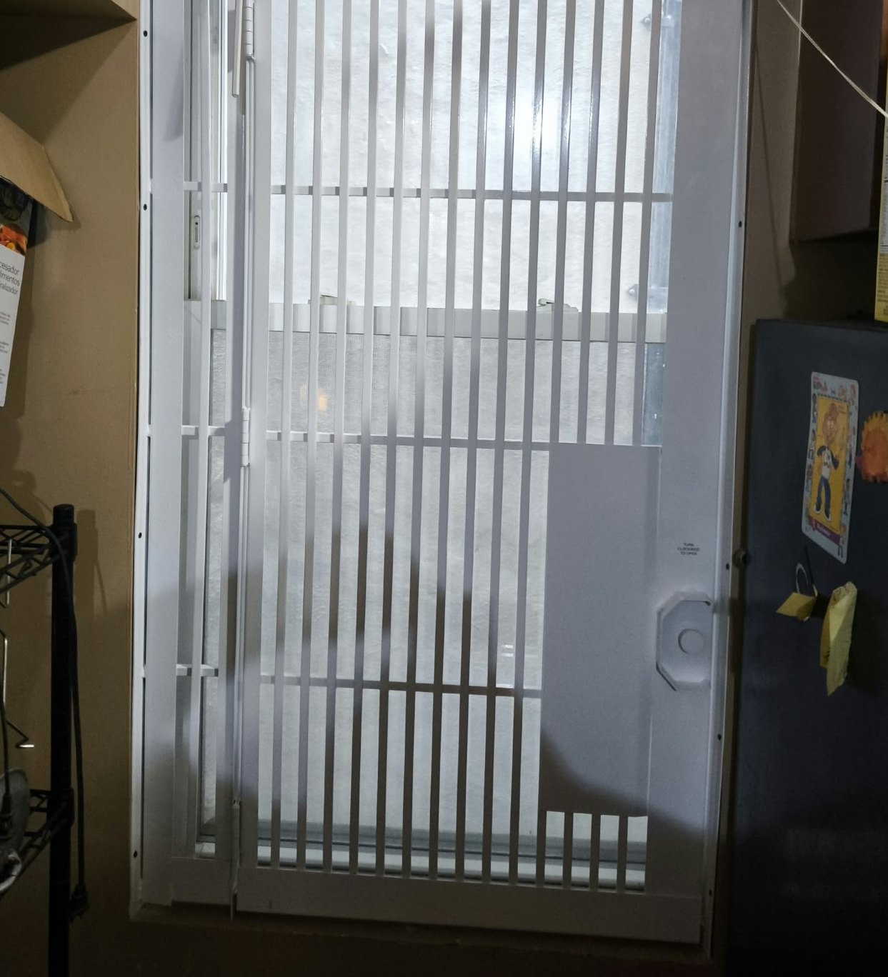 Fire escape window gate with turn latch - Metro Local Locksmith New white fire escape window gate with an inside turn-to-open latch, installed by Metro Local Locksmith in the Bronx