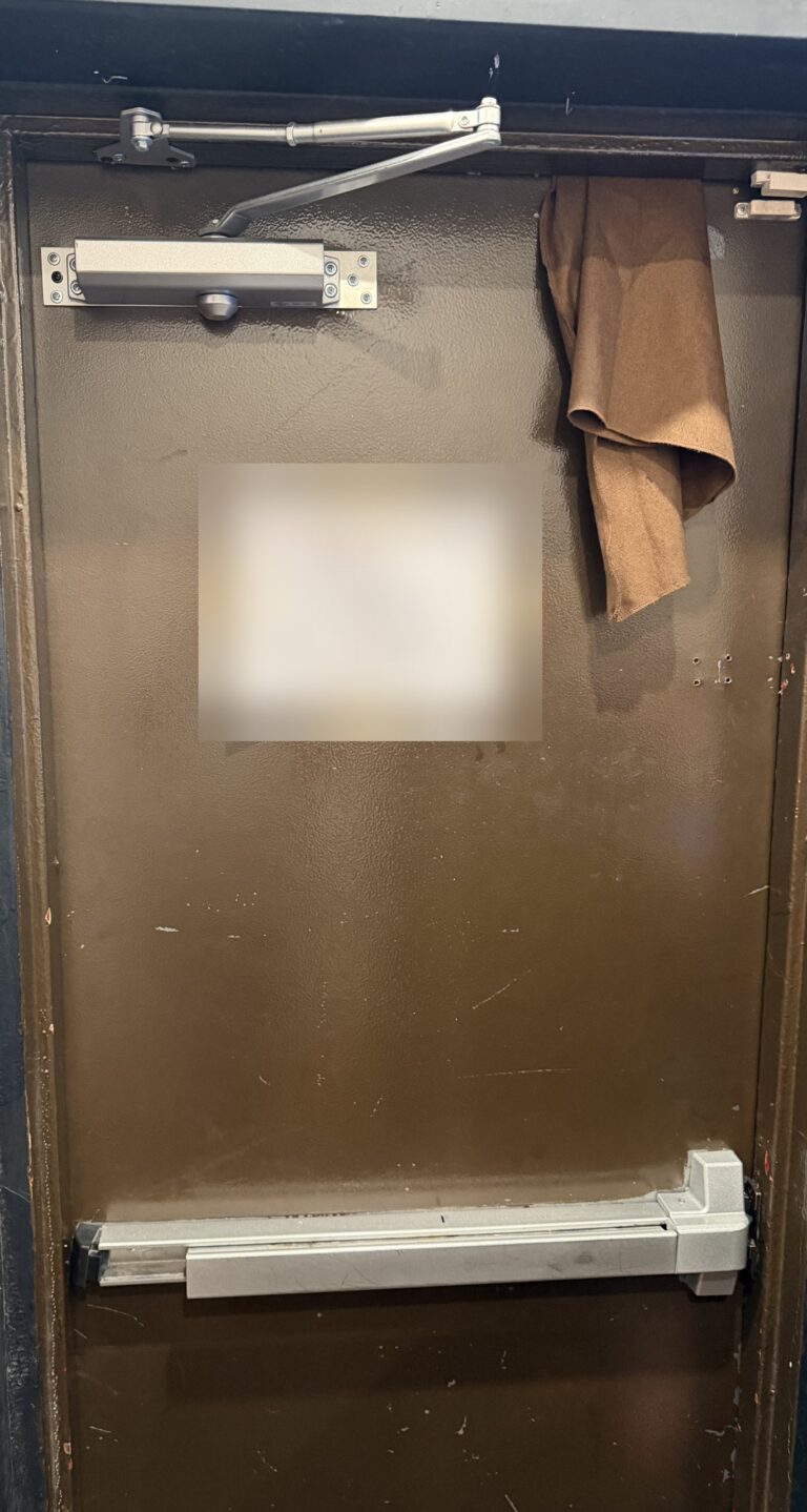 Fire-rated metal door with a commercial push bar and door closer, installed by Metro Local Locksmith on the Upper East Side, Manhattan