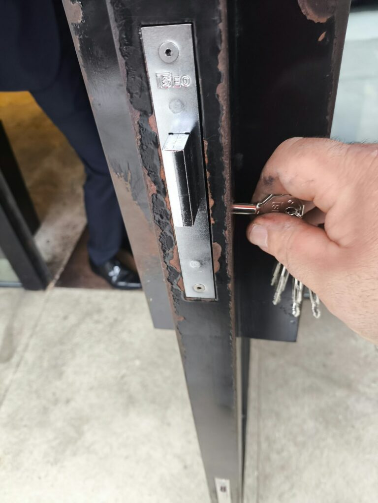 Key turning in a new narrow-style European mortise lockset on a black metal door, installed by Metro Local Locksmith on the Upper East Side, Manhattan