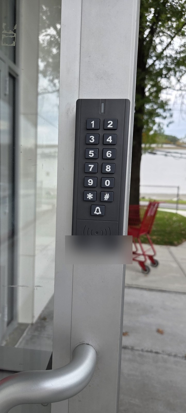 New backlit keypad on a commercial glass entrance, installed by Metro Local Locksmith in Hartsdale, Westchester