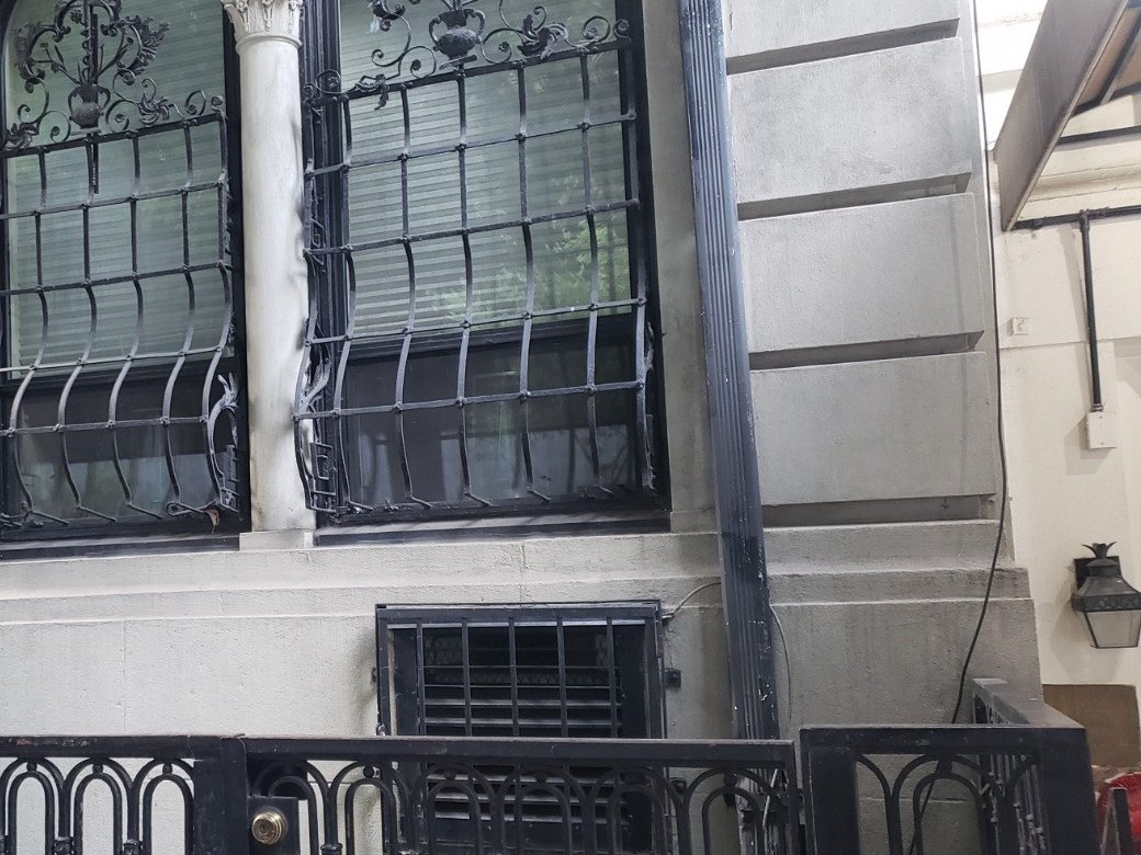 NYC townhouse with wrought-iron window guards and front railing, Metro Local Locksmith