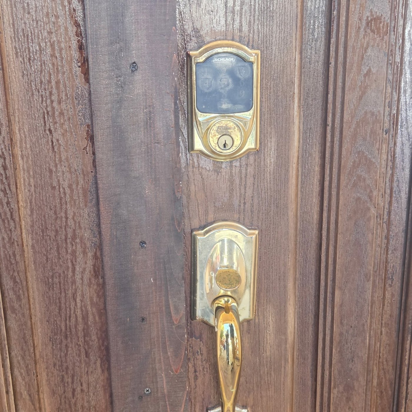 Keypad deadbolt and handleset on front door - Metro Local Locksmith Brass keypad deadbolt and handleset on a residential wood front door, Metro Local Locksmith