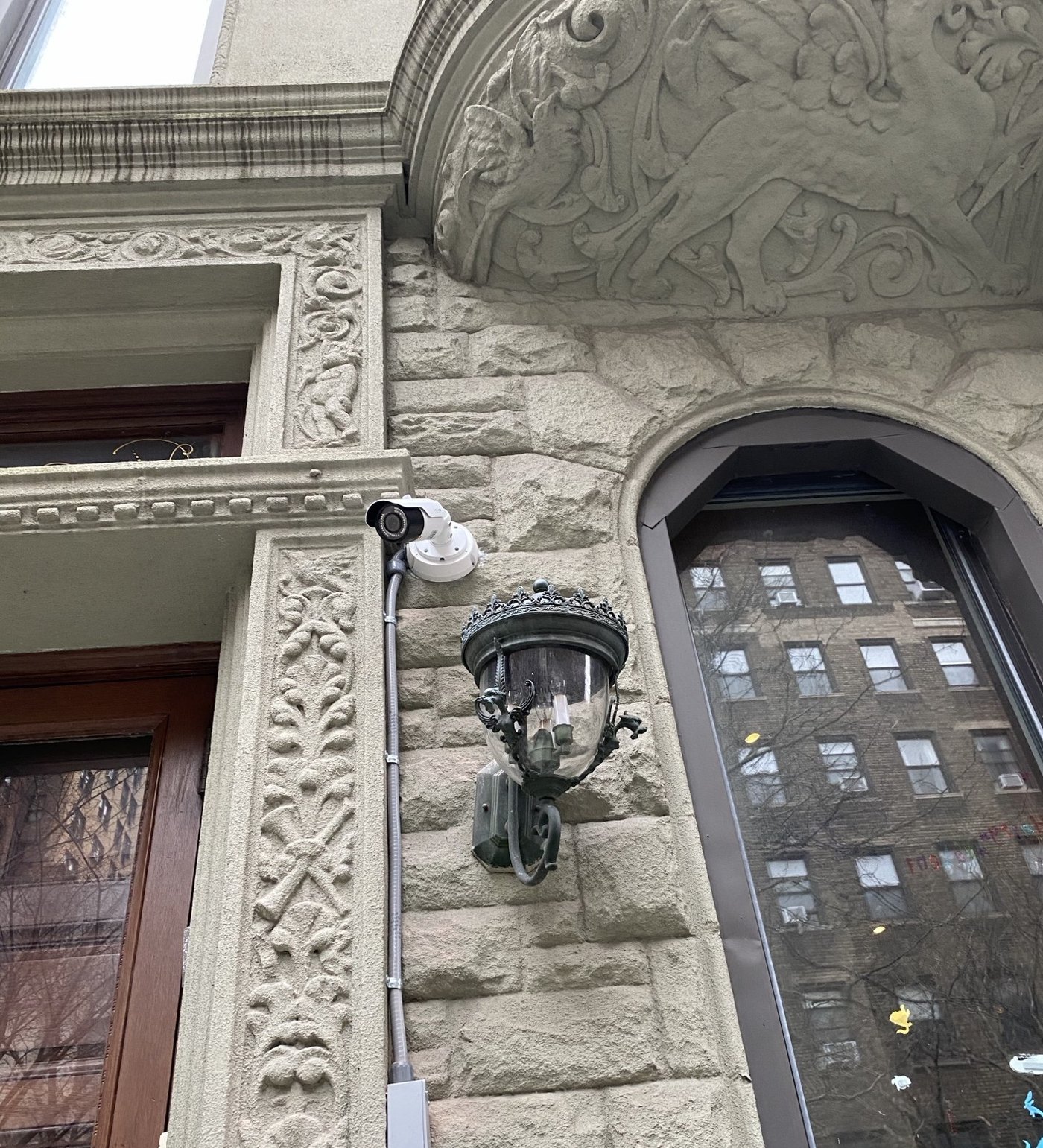 Security camera installed on a historic stone building facade on the Upper West Side by Metro Local Locksmith