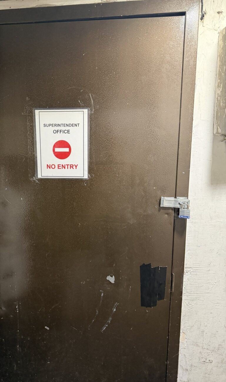 Heavy-duty steel hasp and padlock on a building office door, installed by Metro Local Locksmith on the Upper East Side, Manhattan
