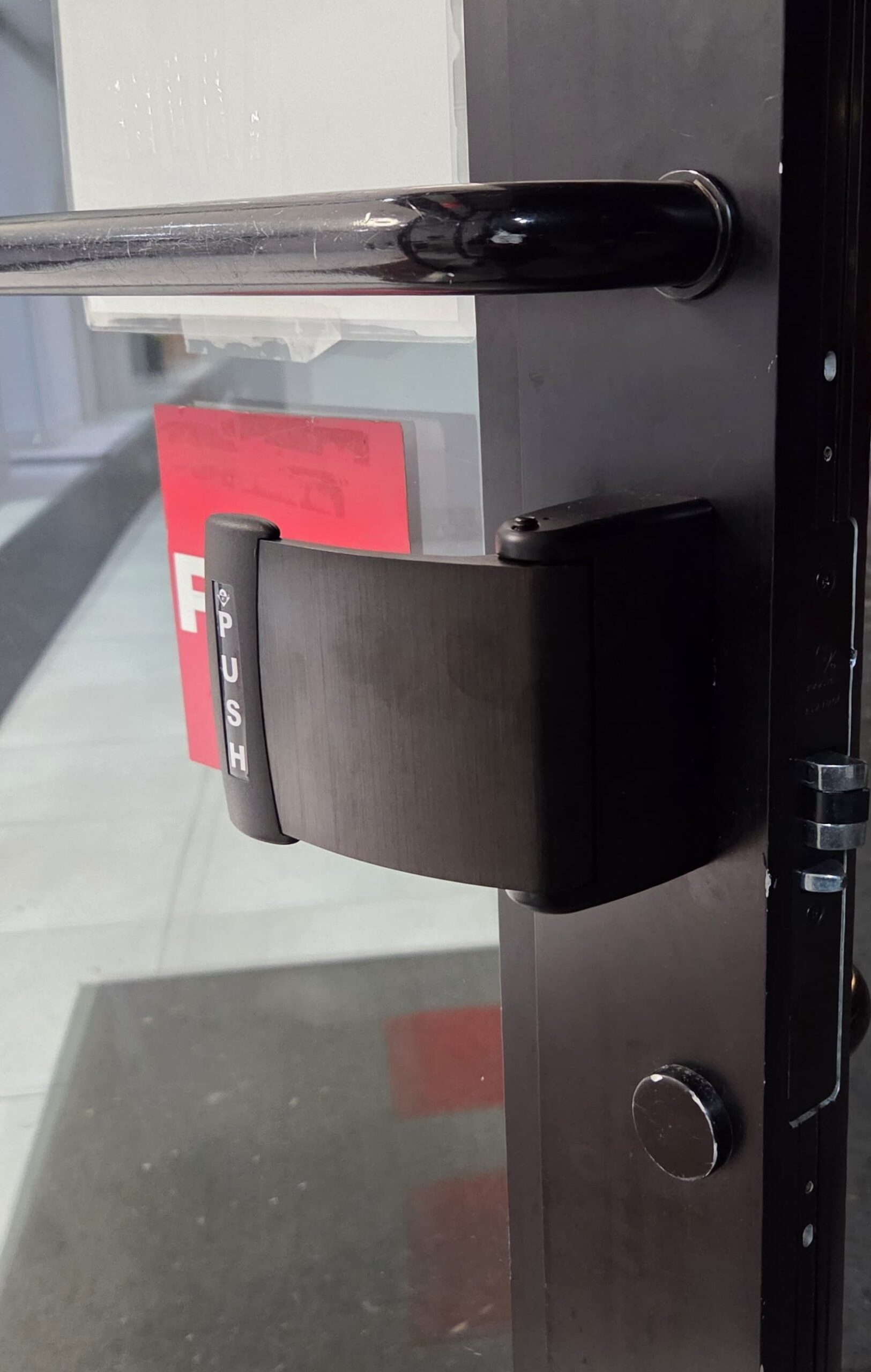 Push paddle exit hardware and pull bar on a commercial aluminum door, Bronx, NYC