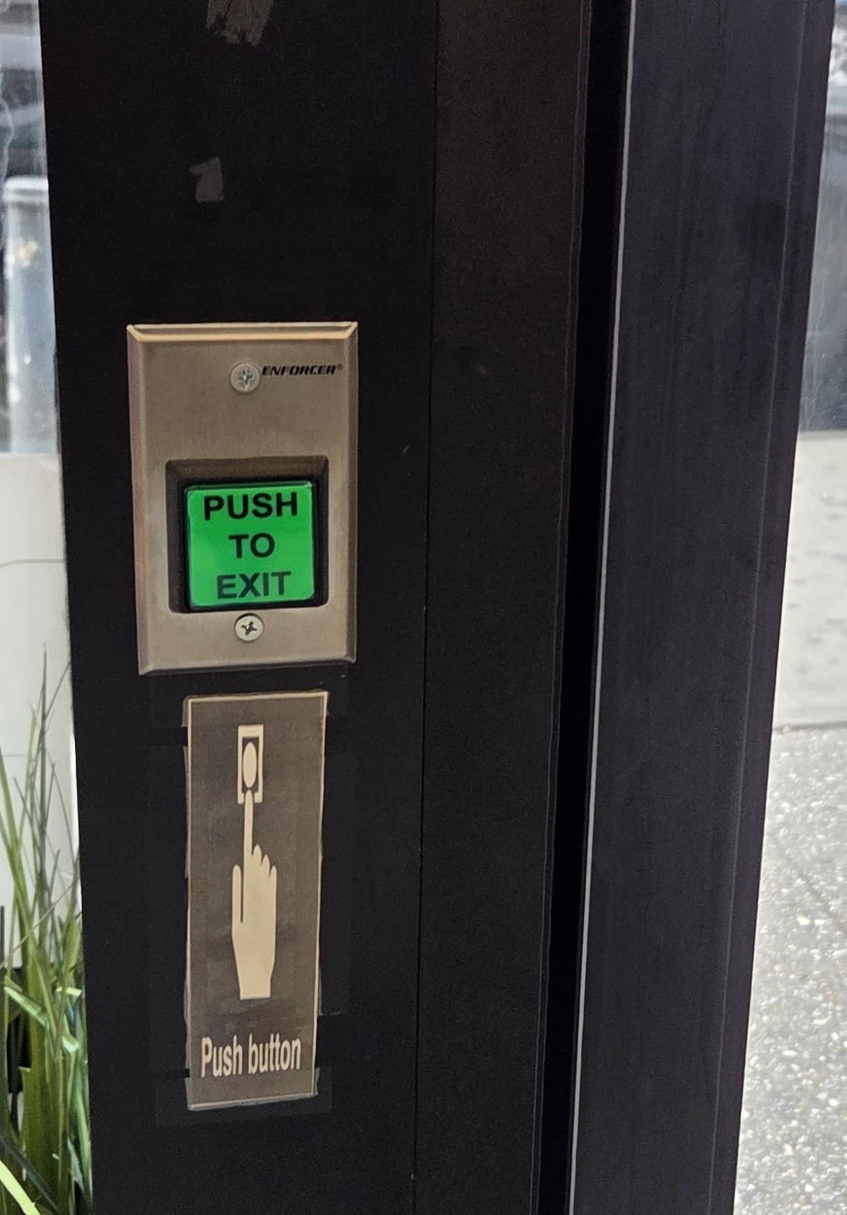 Enforcer PUSH TO EXIT request-to-exit button on a commercial glass door frame, part of a maglock access control setup, Bronx, NYC
